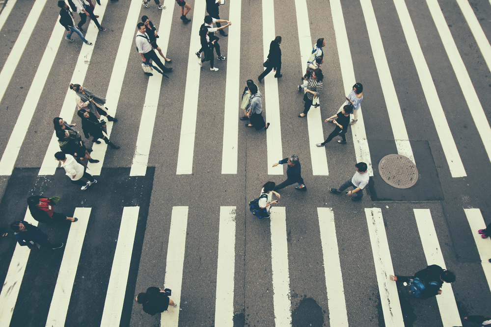 People walking across busy street