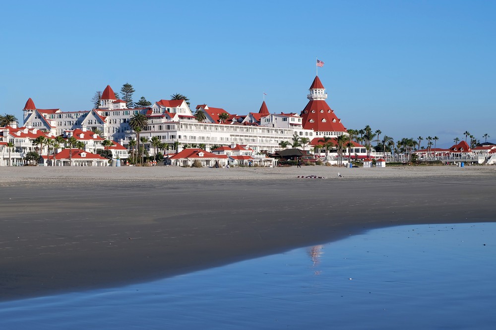 Ultimate 2024 Guide to Living in Coronado | Why You Should Move There 4 shutterstock 582180871 1 The Hotel Del Coronado, viewed from the shoreline on a sunny day.