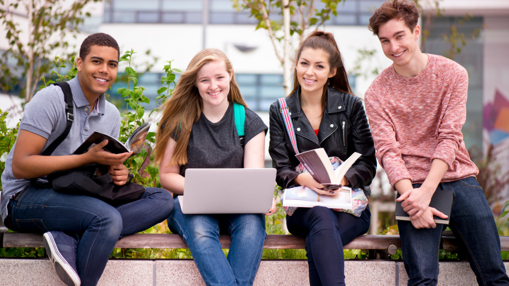 best colleges in the bay area college students sitting on campus bench 1