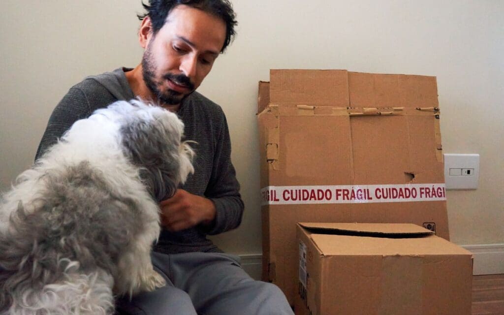 pet and owner by moving boxes