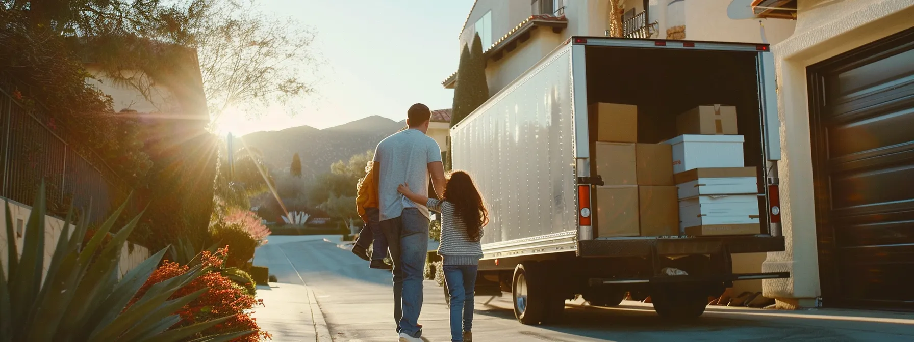 a family happily watching professional movers load a moving truck in front of a scenic los angeles backdrop. a family happily watching professional movers load a moving truck in front of a scenic los angeles backdrop.