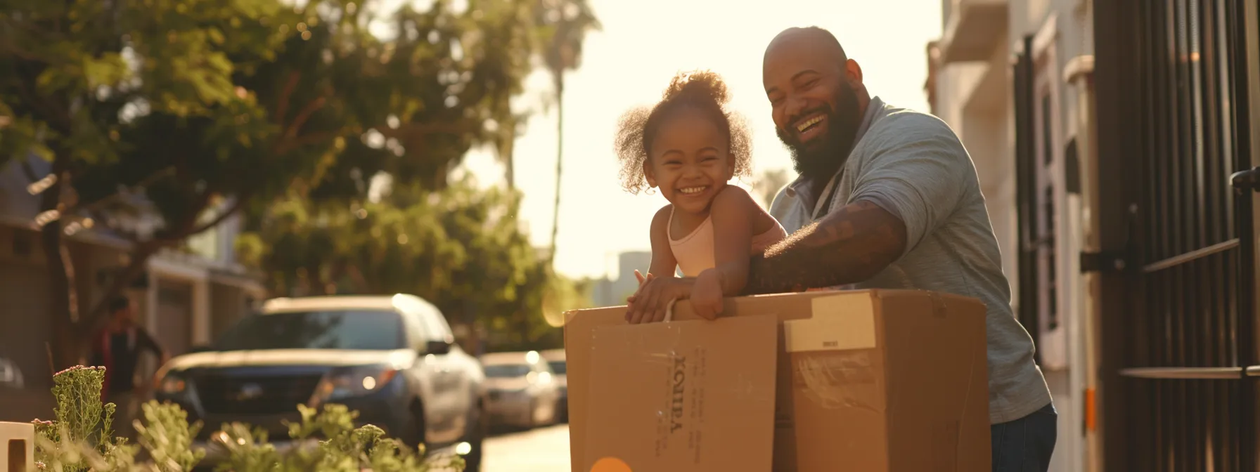 a family smiles as professional movers carefully load boxes into a moving truck in sunny los angeles.