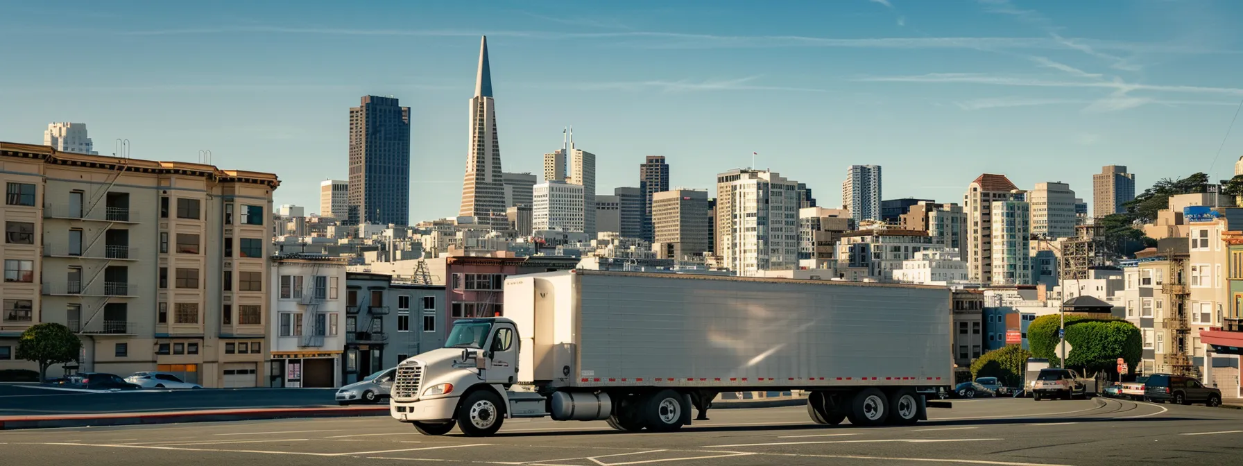 a professional moving truck parked in downtown san francisco, with the iconic city skyline in the background, showcasing a reliable long-distance mover in action.