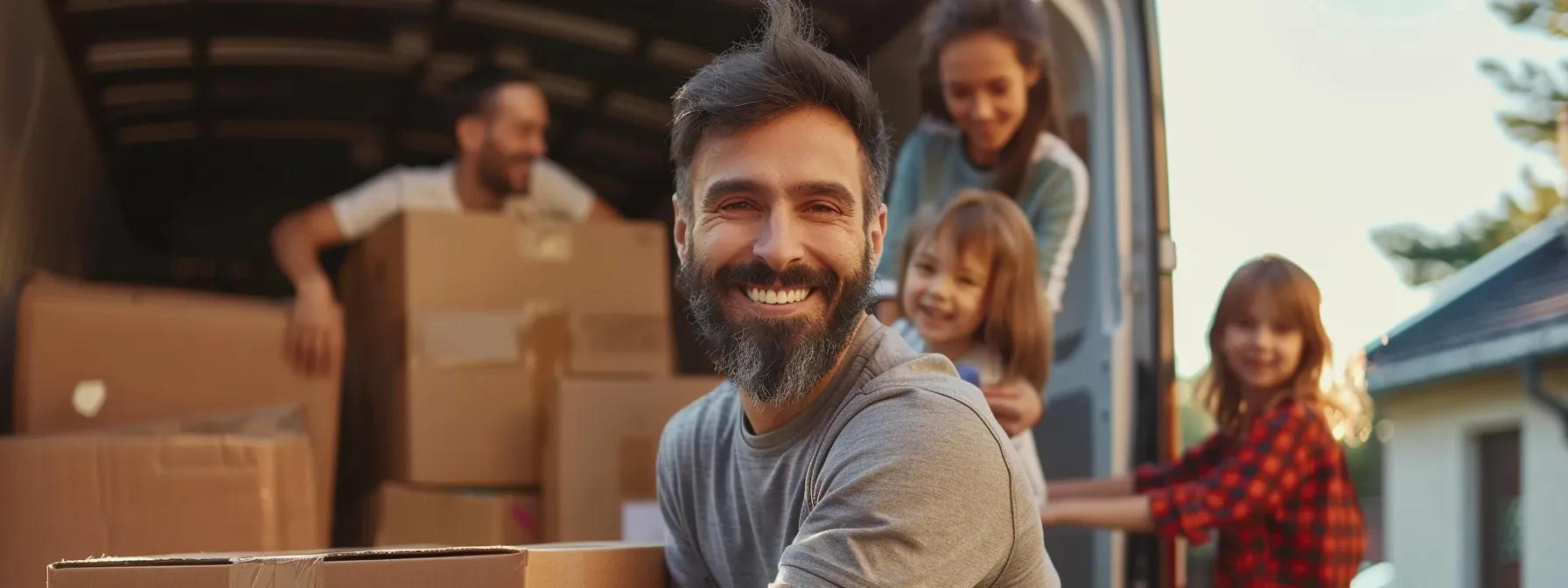 a smiling family watches as professional movers carefully pack their belongings into a moving truck, embodying the stress-free and efficient small relocation experience.
