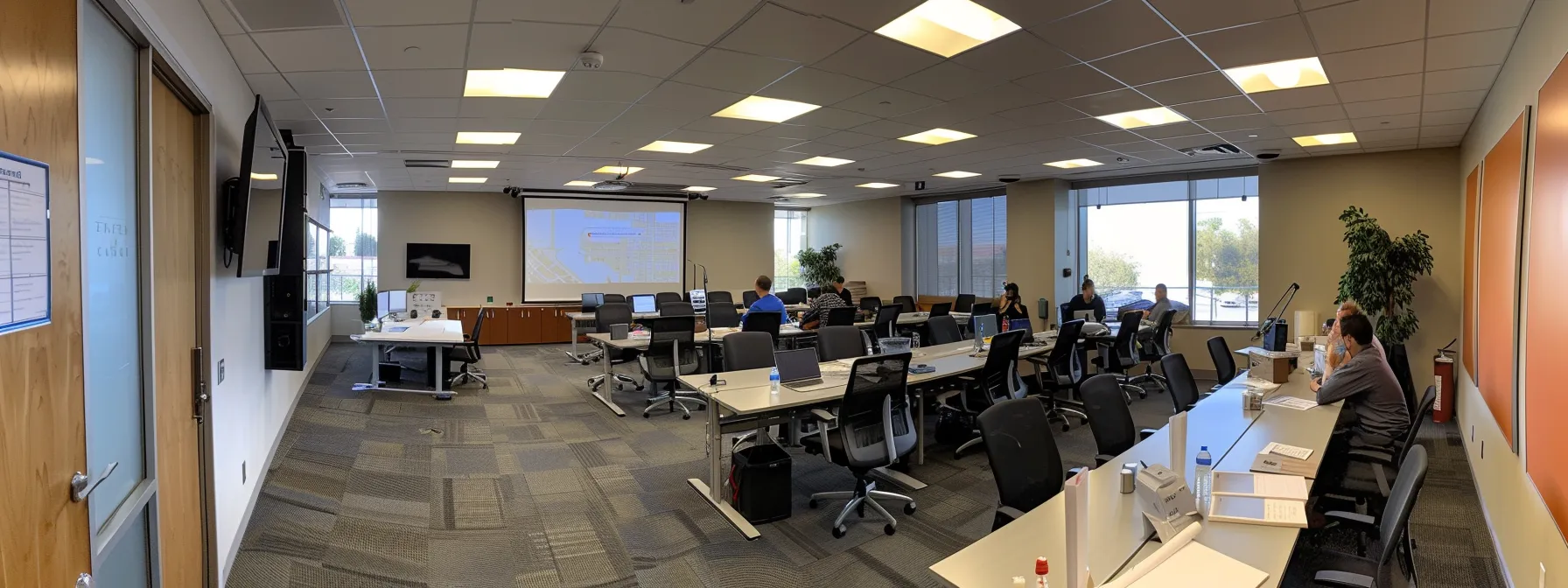 a conference room filled with movers discussing blueprints and timelines under the bright, fluorescent lights of an office in orange county.