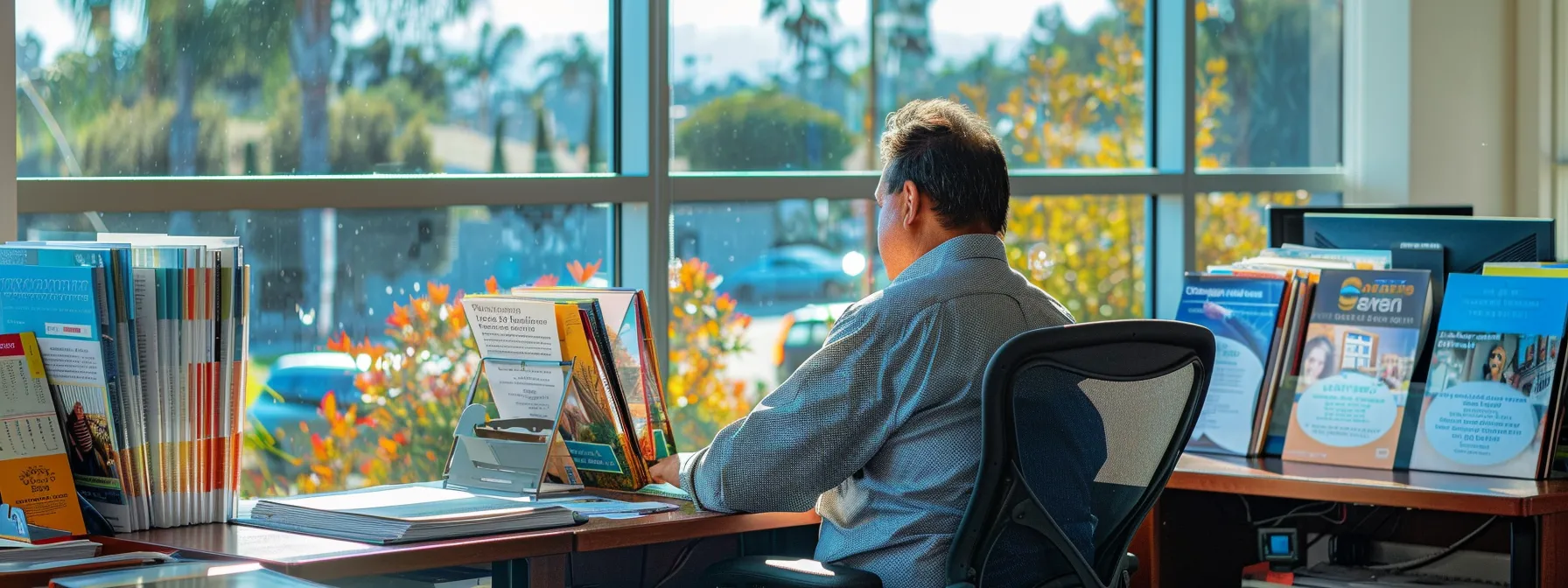a customer sitting at a desk, surrounded by colorful moving brochures, comparing quotes and service options while enjoying the sunny view from a window overlooking irvine, ca. a customer sitting at a desk, surrounded by colorful moving brochures, comparing quotes and service options while enjoying the sunny view from a window overlooking irvine, ca.