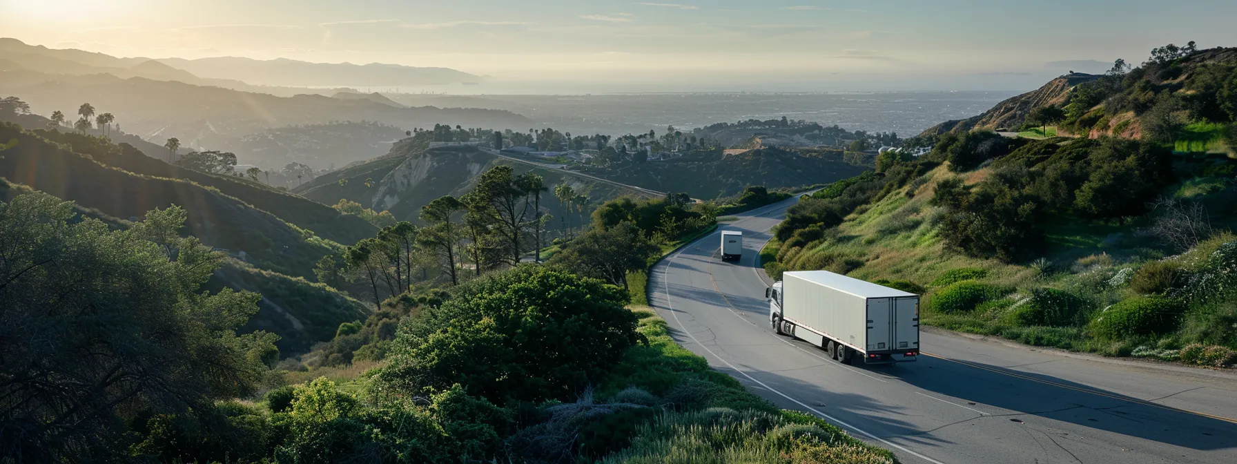 a moving truck loaded with recyclable boxes winding through a scenic los angeles route, showcasing eco-friendly moving practices and supporting green initiatives.